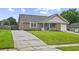 Single-story brick house with a manicured lawn, a charming front porch, and an attached garage at 313 Janice St, Goose Creek, SC 29445