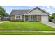 Welcoming single-story brick home with manicured lawn, front porch, and attached garage at 313 Janice St, Goose Creek, SC 29445