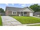 Charming single-story brick home with well-manicured lawn, front porch, and attached garage at 313 Janice St, Goose Creek, SC 29445