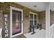 Inviting front porch with brick siding, a 'WELCOME' sign, and seating at 313 Janice St, Goose Creek, SC 29445