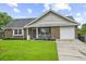 Charming single-story brick home with a well-maintained lawn, driveway, and front porch at 313 Janice St, Goose Creek, SC 29445