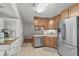 Bright kitchen features stainless steel appliances and neutral color palette with wood cabinets at 313 Janice St, Goose Creek, SC 29445