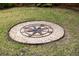 Backyard featuring a unique compass design surrounded by grass, adding a distinctive and decorative element at 34 Formosa Dr, Charleston, SC 29407
