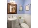 Powder room showcasing a pedestal sink, decorative mirror, and wainscoting creating an elegant ambiance at 34 Formosa Dr, Charleston, SC 29407