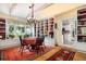Cozy dining area featuring a chandelier, built-in shelving, and view of a connecting kitchen space at 34 Formosa Dr, Charleston, SC 29407