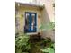 Home exterior showcasing blue double doors, brick steps, and decorative sconces creating a charming and inviting entrance at 34 Formosa Dr, Charleston, SC 29407