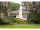 Inviting facade with manicured lawn and beautiful landscaping surrounding a charming home with a blue front door at 34 Formosa Dr, Charleston, SC 29407