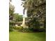 Charming home with manicured lawn and lush landscaping under mature trees draped with Spanish moss at 34 Formosa Dr, Charleston, SC 29407