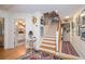 Inviting foyer with staircase, hardwood floors, and artistic decor, blending classic charm with modern aesthetics at 34 Formosa Dr, Charleston, SC 29407