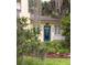 Charming home featuring a blue front door adorned with a wreath, complemented by a lush garden at 34 Formosa Dr, Charleston, SC 29407