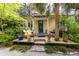 Charming front porch features a seating area surrounded by mature landscaping at 34 Formosa Dr, Charleston, SC 29407