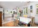 Eat-in kitchen featuring white cabinets, stainless appliances and unique multi-colored chairs at 34 Formosa Dr, Charleston, SC 29407