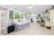 Sunlit living room boasts a daybed, decorative screen, and large windows offering bright and airy space at 34 Formosa Dr, Charleston, SC 29407