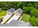 Aerial view of a yellow detached garage with a manicured lawn and flower pots at 3413 Acorn Drop Ln, Johns Island, SC 29455