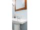 Close-up of a pedestal sink with a decorative faucet and framed mirror, showcasing a classic design at 3413 Acorn Drop Ln, Johns Island, SC 29455