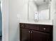Elegant bathroom vanity with a dark cabinet, white countertop, and modern fixtures at 3413 Acorn Drop Ln, Johns Island, SC 29455