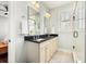 Bathroom with a double vanity, black countertop, walk-in shower, and natural light from a window at 3413 Acorn Drop Ln, Johns Island, SC 29455