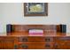 Close up of antique-style wooden desk, featuring books and modern speakers at 3413 Acorn Drop Ln, Johns Island, SC 29455