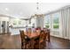 Bright dining area featuring hardwood floors, modern chandelier, and seamless flow to the updated kitchen at 3413 Acorn Drop Ln, Johns Island, SC 29455