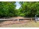 Community dog park featuring a fenced area with benches and wooded surroundings at 3413 Acorn Drop Ln, Johns Island, SC 29455