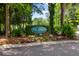 Community entrance sign surrounded by lush landscaping and colorful flowers at 3413 Acorn Drop Ln, Johns Island, SC 29455