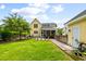 Charming yellow home with a well-manicured lawn and beautiful landscaping at 3413 Acorn Drop Ln, Johns Island, SC 29455