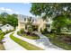 Charming two-story home with yellow siding, lush landscaping, and a curved driveway at 3413 Acorn Drop Ln, Johns Island, SC 29455
