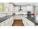 Stylish kitchen with white cabinets, black countertops, a kitchen island, and stainless steel appliances at 3413 Acorn Drop Ln, Johns Island, SC 29455