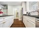Open concept kitchen featuring white cabinetry, stainless steel appliances, and dark wood flooring at 3413 Acorn Drop Ln, Johns Island, SC 29455