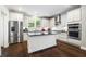Modern kitchen with stainless steel appliances, white cabinetry, black countertops, and dark wood floors at 3413 Acorn Drop Ln, Johns Island, SC 29455