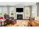 Cozy living room featuring fireplace, natural light, and comfortable armchairs at 3413 Acorn Drop Ln, Johns Island, SC 29455