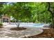 Community pool area with ample lounge seating, surrounded by lush trees at 3413 Acorn Drop Ln, Johns Island, SC 29455