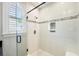 Bright shower featuring subway tile with decorative band, glass door, built-in niche and window at 3413 Acorn Drop Ln, Johns Island, SC 29455