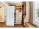 Spacious walk-in closet featuring custom wood organizers, drawers, shelving and bench seating area at 3413 Acorn Drop Ln, Johns Island, SC 29455