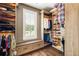 Large walk-in closet with custom shelving and storage solutions, including shoe racks and clothes rails at 3413 Acorn Drop Ln, Johns Island, SC 29455