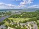 Aerial view showcases the golf course, water features, and neighborhood homes in the community at 3601 Colonel Vanderhorst Cir, Mount Pleasant, SC 29466