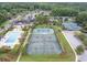 Beautiful aerial view of the neighborhood pool, tennis courts, and clubhouse surrounded by lush green trees at 3601 Colonel Vanderhorst Cir, Mount Pleasant, SC 29466