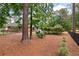 A charming red brick home is surrounded by lush landscaping and a black metal fence at 3601 Colonel Vanderhorst Cir, Mount Pleasant, SC 29466