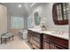 Bright bathroom featuring marble countertops, a standalone tub, and an ornate cabinet at 3601 Colonel Vanderhorst Cir, Mount Pleasant, SC 29466