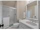 Bathroom with white cabinets, shower, toilet, and vanity with an oval sink and decorative mirror at 3601 Colonel Vanderhorst Cir, Mount Pleasant, SC 29466