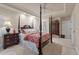 Bedroom with carpet, four-poster bed, decorative bedding, white trim, ceiling fan, and dresser at 3601 Colonel Vanderhorst Cir, Mount Pleasant, SC 29466