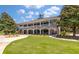 Beautiful clubhouse exterior with a large lawn and multiple entrances for social and recreational activities at 3601 Colonel Vanderhorst Cir, Mount Pleasant, SC 29466
