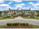 Gorgeous clubhouse with barrel roof with multiple entryways and colorful exteriors and manicured lawn at 3601 Colonel Vanderhorst Cir, Mount Pleasant, SC 29466