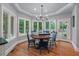 Bright dining area features many windows, hardwood floors, and modern chandelier at 3601 Colonel Vanderhorst Cir, Mount Pleasant, SC 29466
