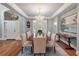 Elegant dining room features a crystal chandelier, hardwood floors, and refined decor at 3601 Colonel Vanderhorst Cir, Mount Pleasant, SC 29466