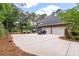 Long driveway leading to a three-car garage and a spacious backyard with golf cart at 3601 Colonel Vanderhorst Cir, Mount Pleasant, SC 29466