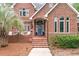 Charming brick home with a welcoming blue front door and meticulously landscaped yard at 3601 Colonel Vanderhorst Cir, Mount Pleasant, SC 29466