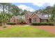 Stunning brick home with mature landscaping, lush lawn, and inviting walkway at 3601 Colonel Vanderhorst Cir, Mount Pleasant, SC 29466