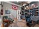 Beautiful home office features built-in shelving, hardwood floors, and comfortable seating at 3601 Colonel Vanderhorst Cir, Mount Pleasant, SC 29466