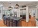 Gourmet kitchen boasts dark island with granite countertops, stainless steel appliances, and custom cabinets at 3601 Colonel Vanderhorst Cir, Mount Pleasant, SC 29466